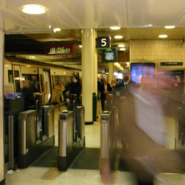 People going through ticket barriers in Charing Cross