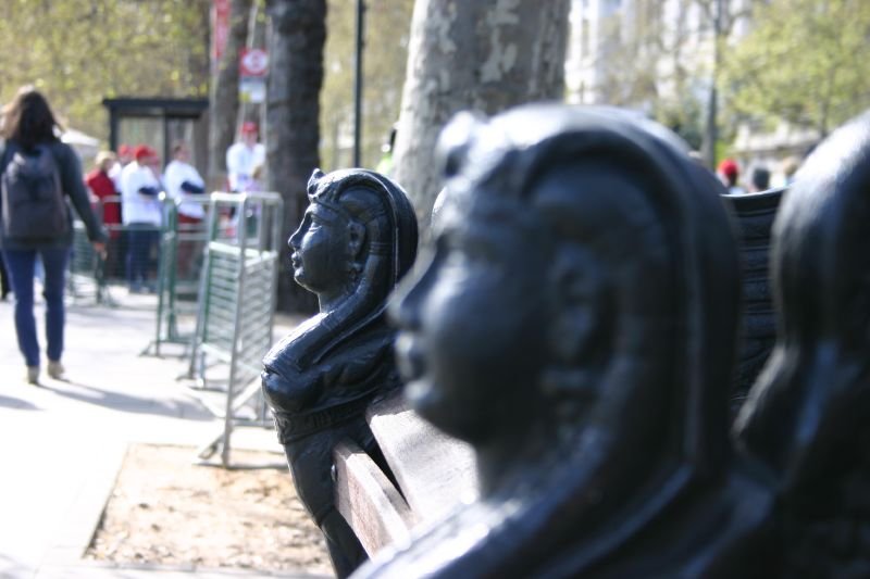 Statuettes on bench arms