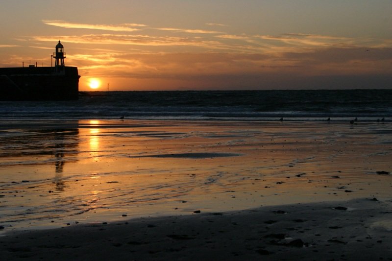 Sun setting beside the lighthouse