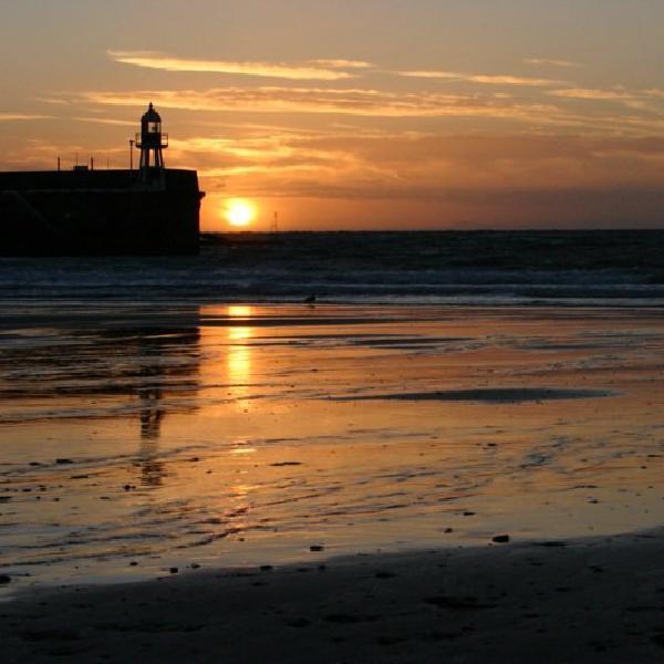 Sun setting beside the lighthouse