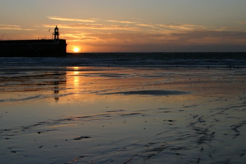 Sun setting beside the lighthouse