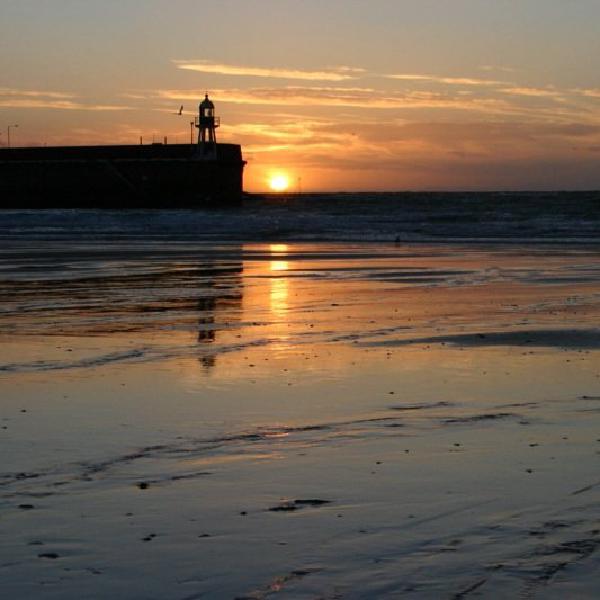 Sun setting beside the lighthouse