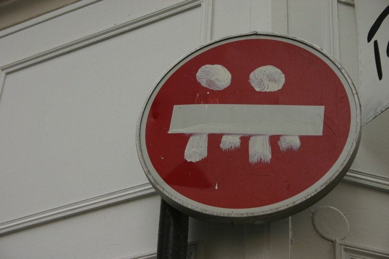 A sign with a grin