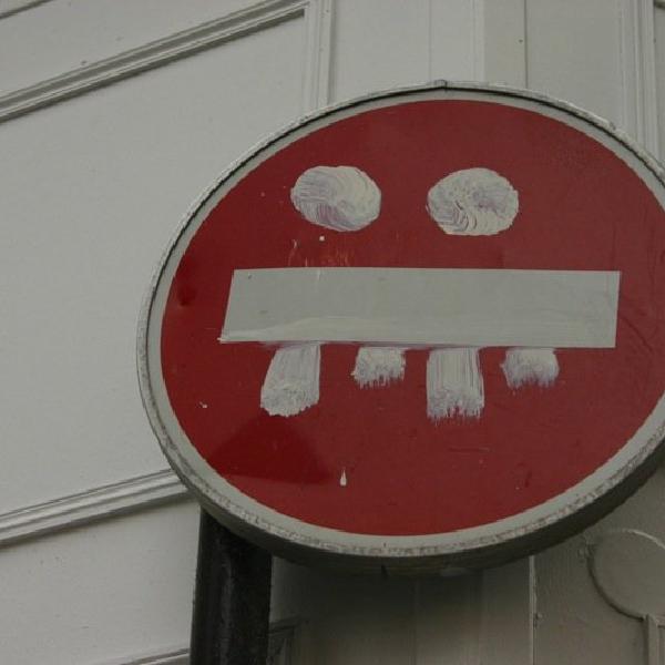 A sign with a grin