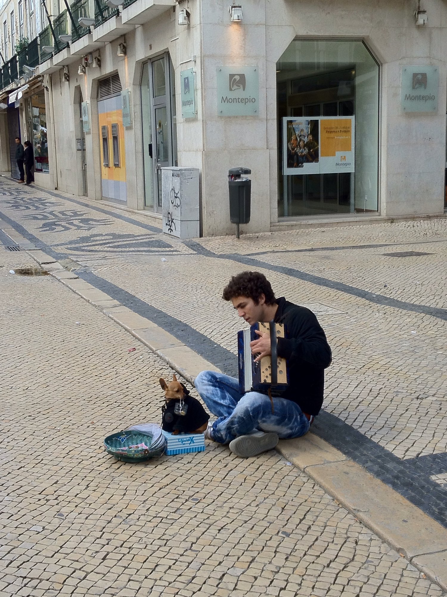 Busking with his dog with its basket