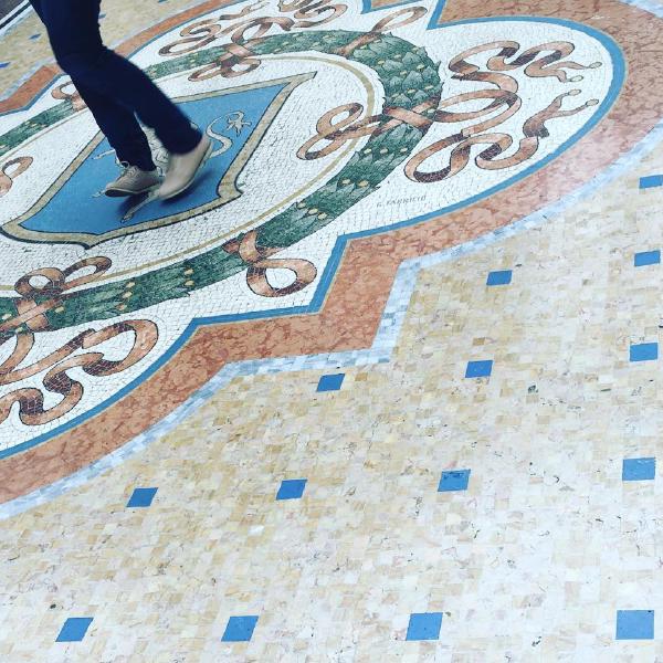 Spinning on the bull for good luck in Milans Galleria Vittorio Emanuele II