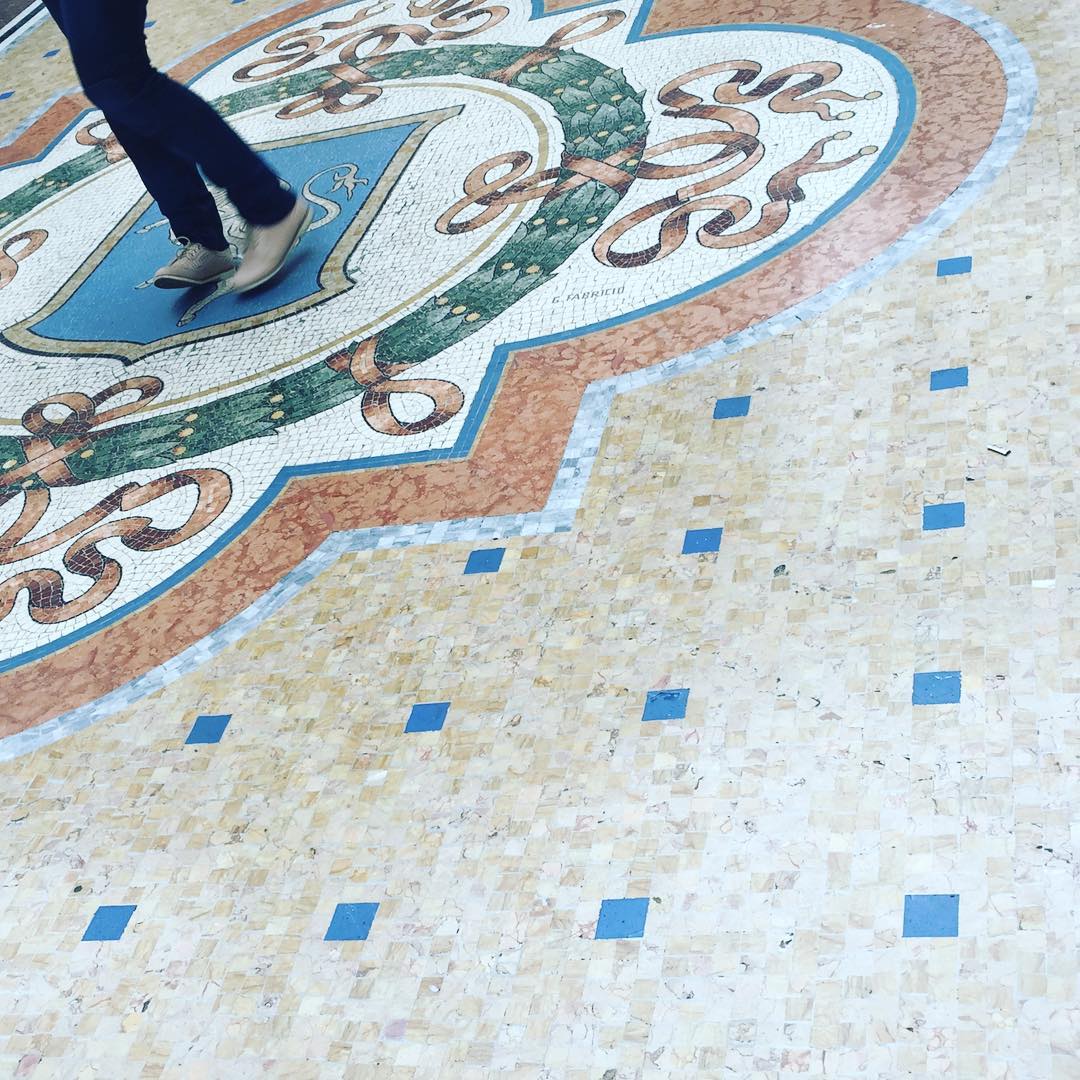 Spinning on the bull for good luck in Milans Galleria Vittorio Emanuele II