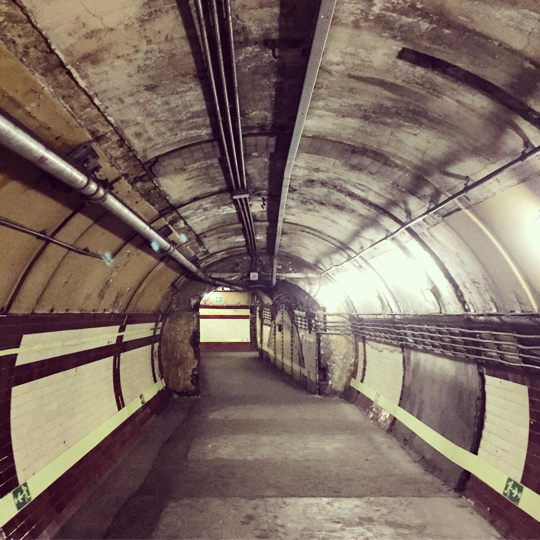 Inside Down Street station with its maroon colour scheme